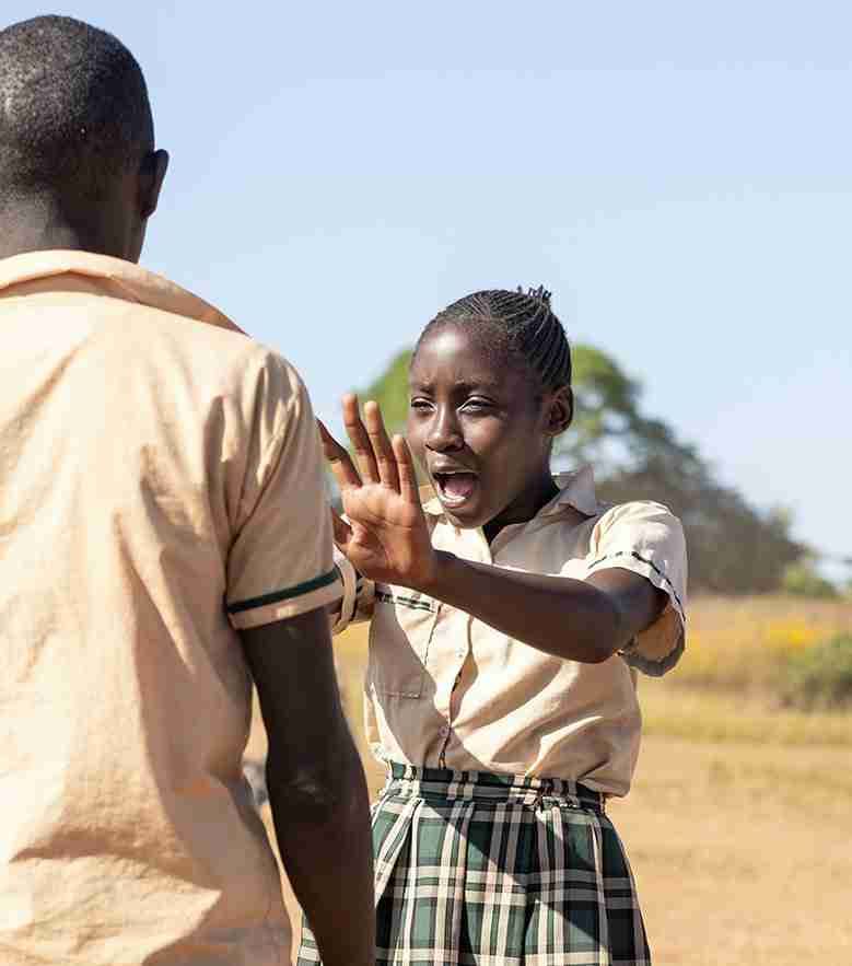 A girl counting on her fingers during a lesson outside.
